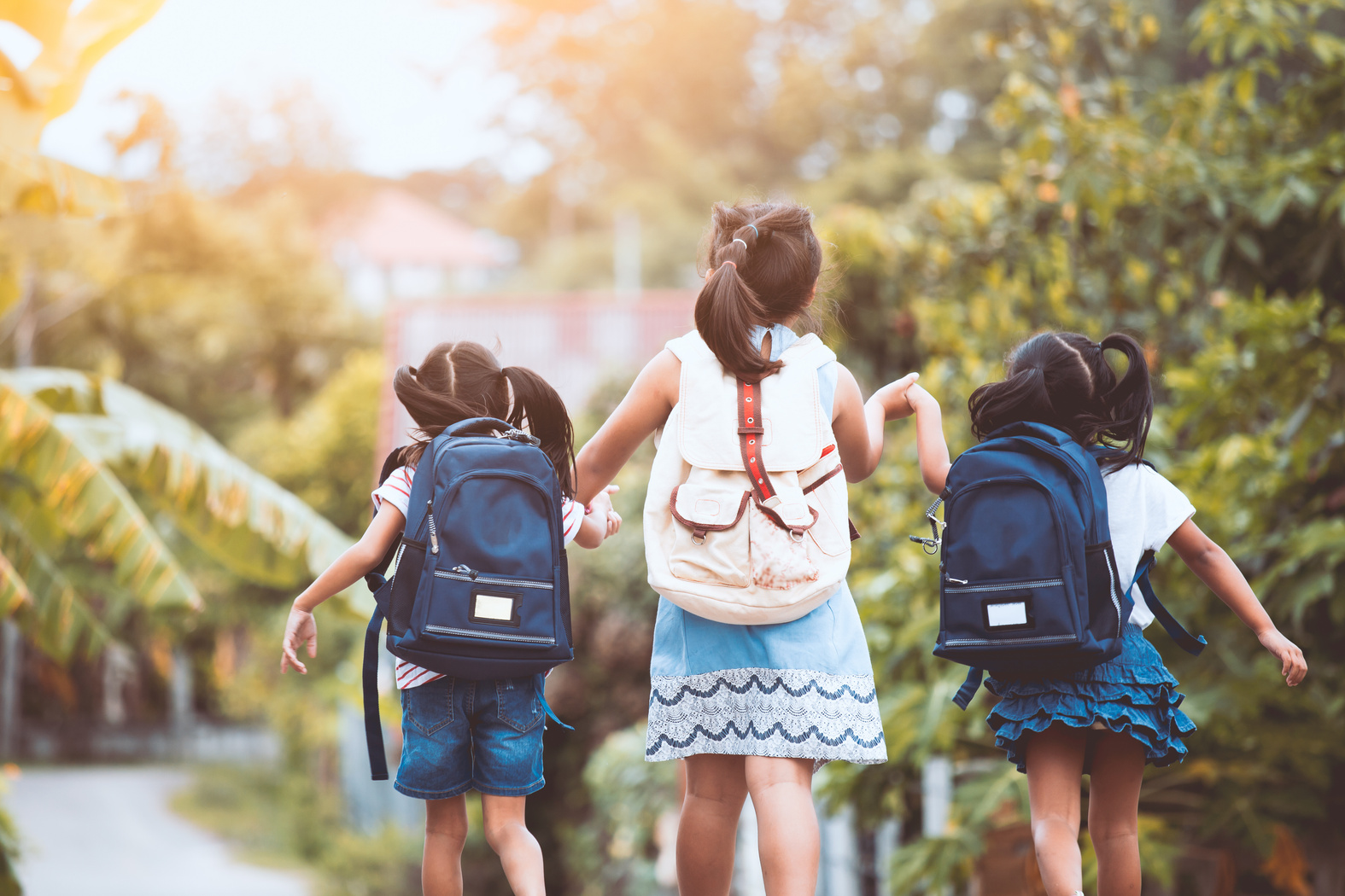 Asian pupil kids with backpack going to school together